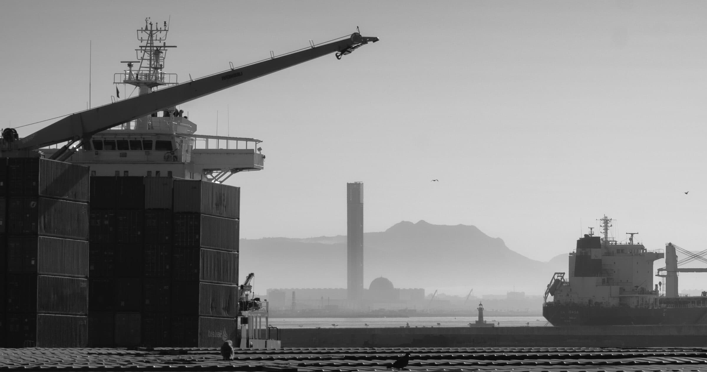 Container port with a city skyline in the haze